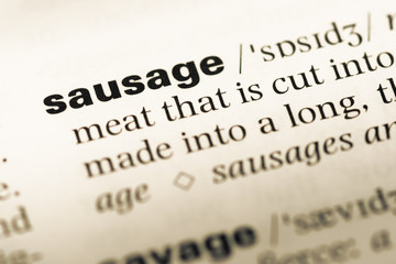 Fototapeta premium Close up of old English dictionary page with word sausage
