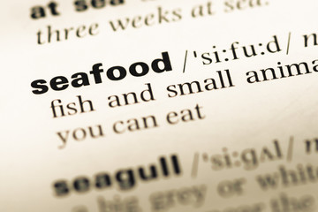 Obraz premium Close up of old English dictionary page with word seafood