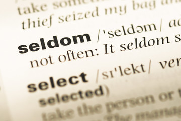 Close up of old English dictionary page with word seldom