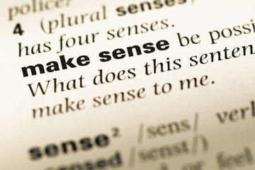 Close up of old English dictionary page with word make sense