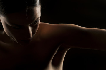 silhouette portrait of a woman with naked shoulders on a black background