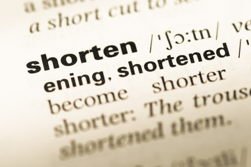 Obraz premium Close up of old English dictionary page with word shorten