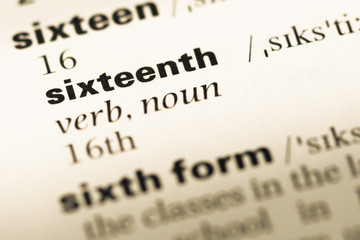 Fototapeta premium Close up of old English dictionary page with word sixteenth