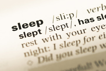 Close up of old English dictionary page with word sleep
