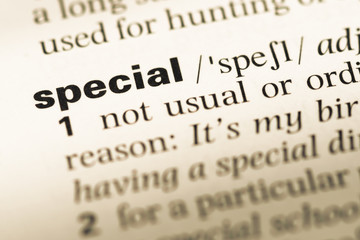 Obraz premium Close up of old English dictionary page with word special