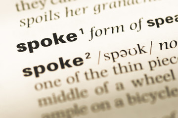 Obraz premium Close up of old English dictionary page with word spoke