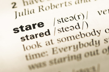 Fototapeta premium Close up of old English dictionary page with word stare