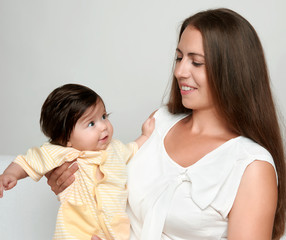 portrait of mother and baby on white