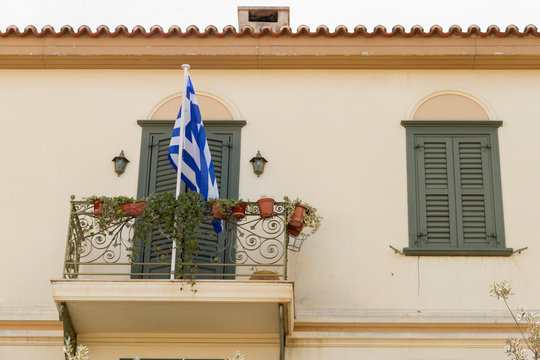 Traditional building balcony with Greek flag in Plaka area, Athe