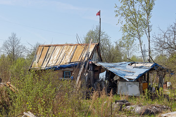 Blue sky. Abandoned house. Abandoned garden plot. rustic house. poor abandoned house.
