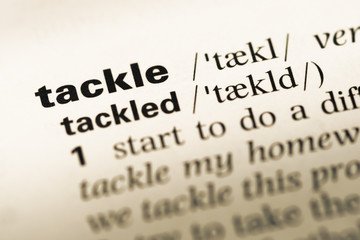 Close up of old English dictionary page with word tackle