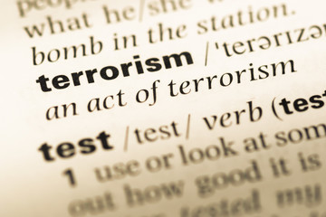 Fototapeta premium Close up of old English dictionary page with word terrorism