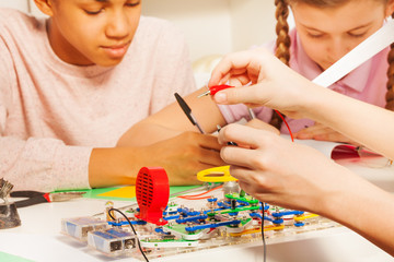 Hands of young student with potential probes