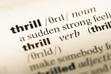 Fototapeta premium Close up of old English dictionary page with word thrill