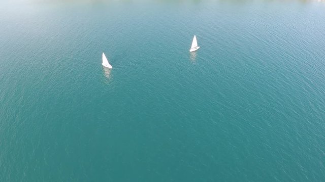 Aerial view of two small sailboats in the sea