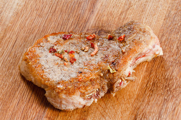 Juicy roasted pork steak with french fries and spices