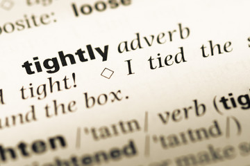 Close up of old English dictionary page with word tightly