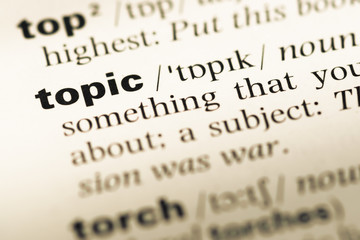Close up of old English dictionary page with word topic