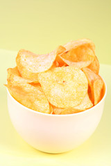 isolated on yellow bowl of potato chips, snack
