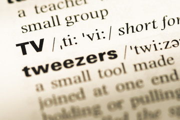 Obraz premium Close up of old English dictionary page with word tv