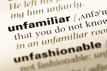 Obraz premium Close up of old English dictionary page with word unfamiliar