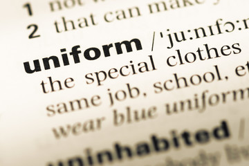 Obraz premium Close up of old English dictionary page with word uniform