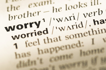 Close up of old English dictionary page with word worry