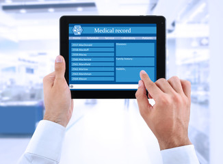 Medical tablet in doctor hands on light background