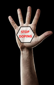Stop doping concept. Male hand with sign isolated on black
