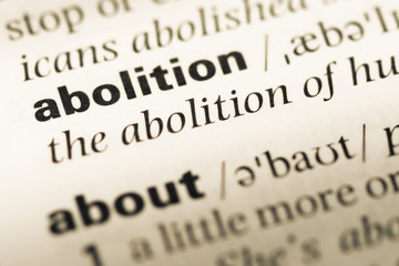 Obraz premium Close up of old English dictionary page with word abolition