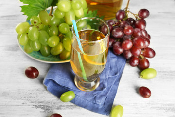 Glass with grape juice on blue napkin