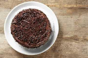 Tasty chocolate cake on wooden background