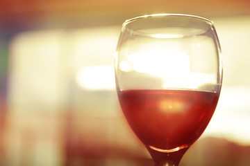 Glass of red wine on blurred background