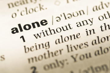 Obraz premium Close up of old English dictionary page with word alone