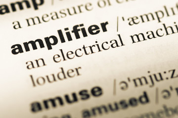 Fototapeta premium Close up of old English dictionary page with word amplifier