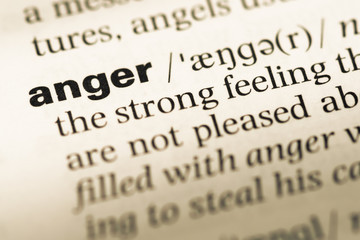 Obraz premium Close up of old English dictionary page with word anger