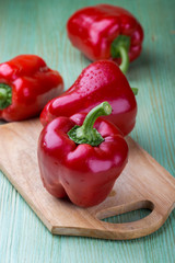 Fresh organic bell peppers on a wooden board