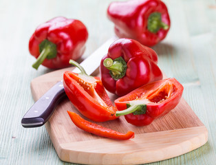 Fresh organic bell peppers on a wooden board