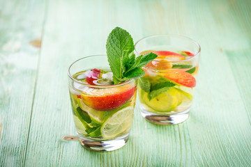 Lemonade drink on a wooden background