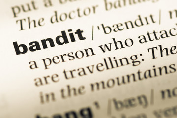 Close up of old English dictionary page with word bandit