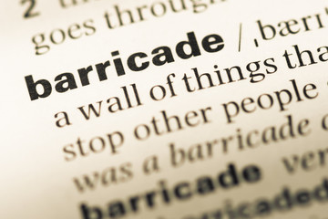 Close up of old English dictionary page with word barricade