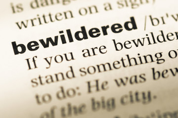 Obraz premium Close up of old English dictionary page with word bewildered