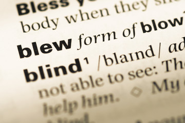 Obraz premium Close up of old English dictionary page with word blew