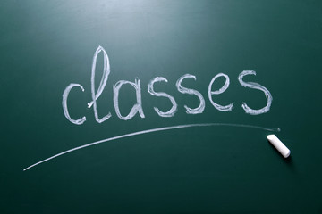 Classes inscription written with white chalk on blackboard