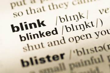 Obraz premium Close up of old English dictionary page with word blink