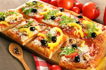 Pieces of delicious pizza on the table, close-up