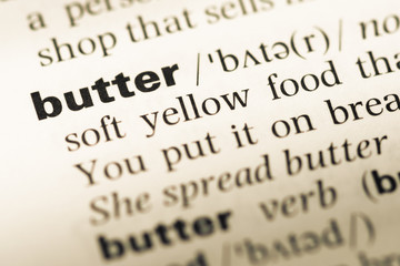 Close up of old English dictionary page with word butter
