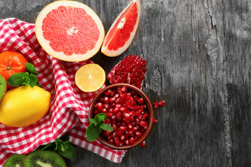 Juicy composition of tropical fruits on wooden background