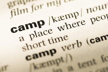 Obraz premium Close up of old English dictionary page with word camp
