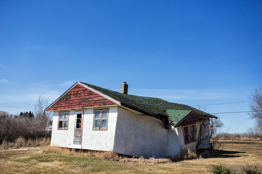A small abandoned house caving in the middle